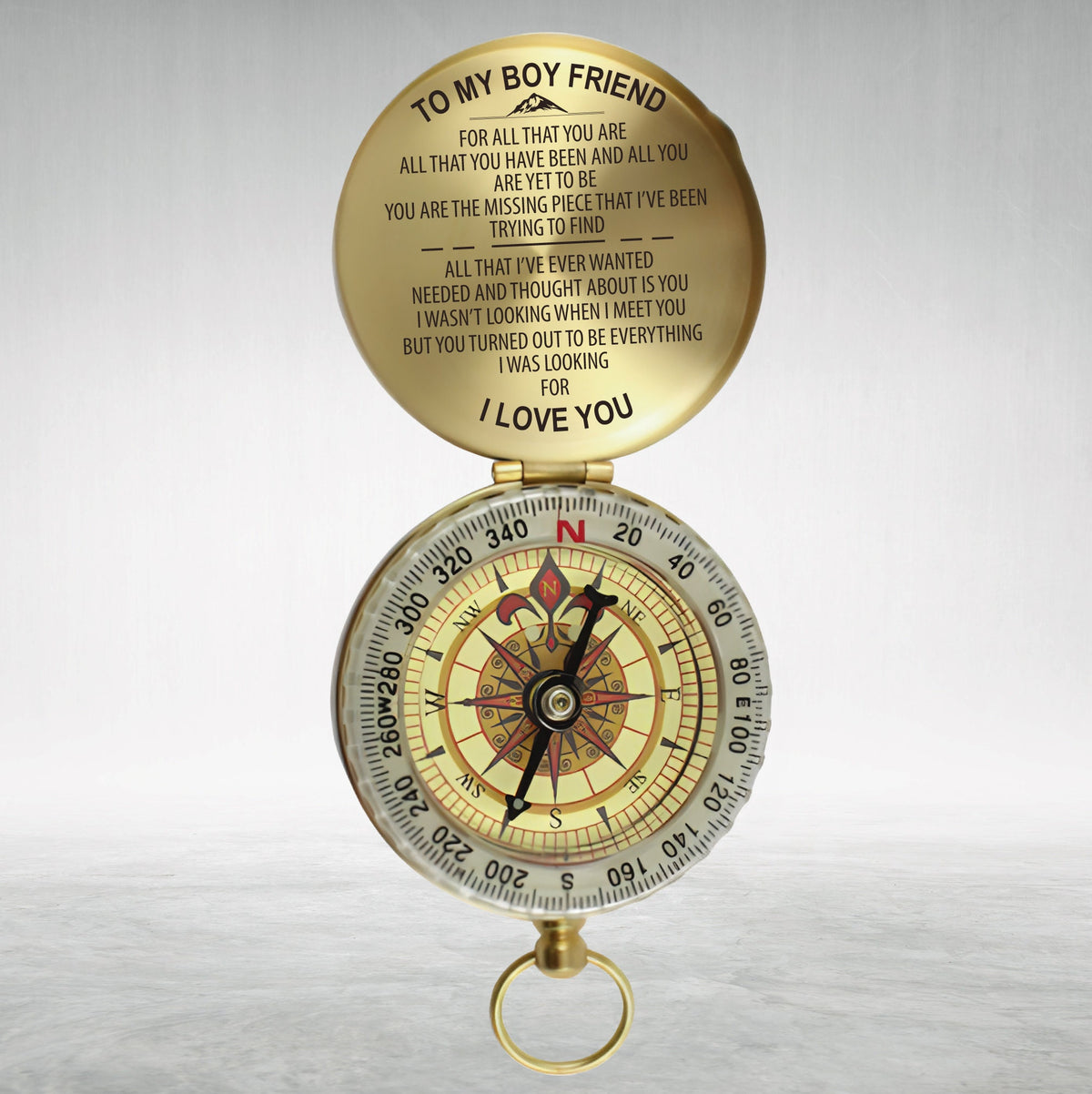 May include: A gold compass with a message on the lid that reads "To my boy friend, for all that you are, all that you have been and all you are yet to be, you are the missing piece that I've been trying to find, all that I've ever wanted needed and thought about is you, I wasn't looking when I meet you but you turned out to be everything I was looking for, I love you."