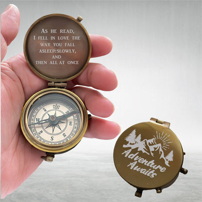 May include: A vintage-style brass compass with a hinged lid. The open compass reveals a directional dial and the text "AS HE READ, I FELL IN LOVE THE WAY YOU FALL ASLEEP: SLOWLY, AND THEN ALL AT ONCE." The closed lid reads "Adventure Awaits."