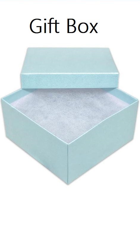 May include: A light blue gift box with a white interior lining. The box is open and the lid is resting on top.