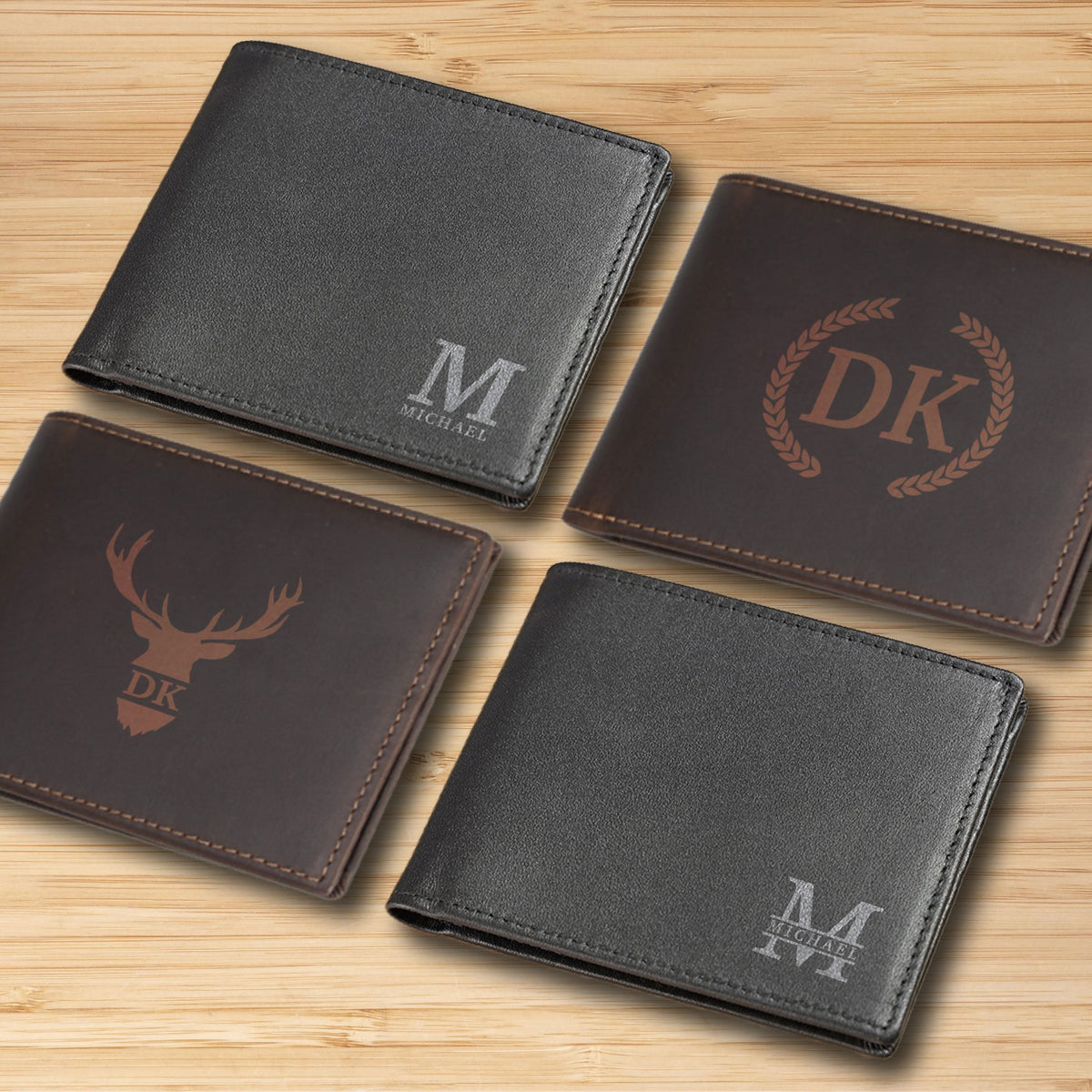 May include: Four different leather wallets with personalized engravings. The wallets are brown and black with different designs, including initials, a deer head, and a wreath.