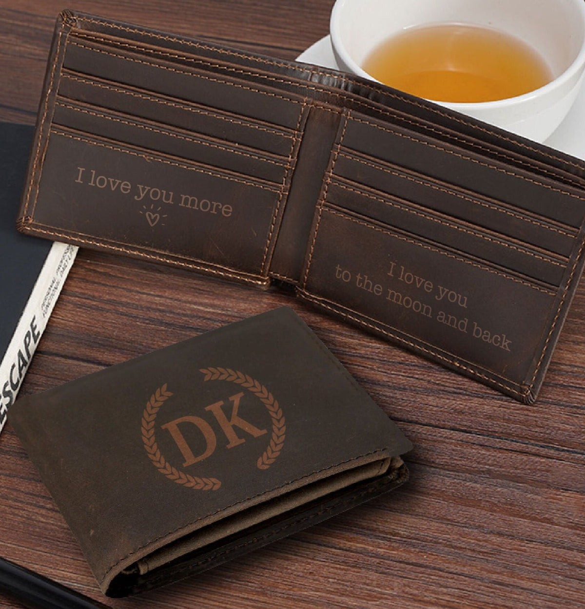 May include: A brown leather wallet with a personalized monogram "DK" and the inscription "I love you more" on the inside. The wallet has multiple card slots and a billfold.