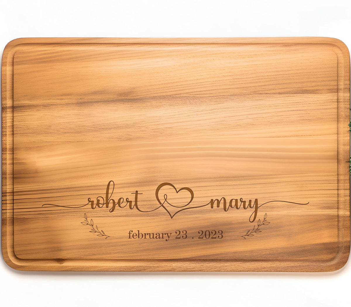 May include: Personalized wooden cutting board with the names "robert & mary" and the date "february 23, 2023" engraved on it.