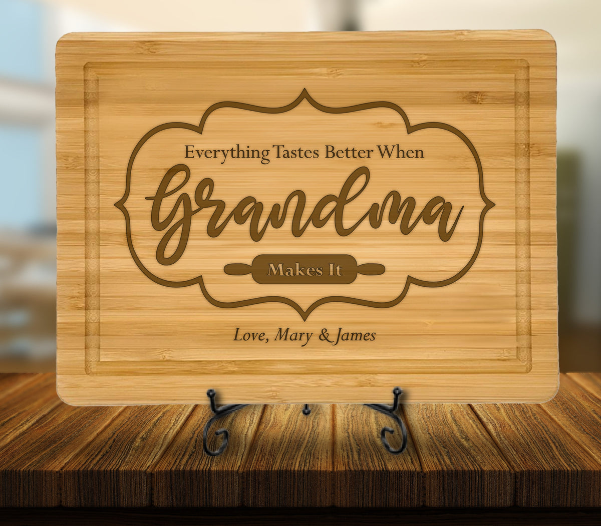 May include: A brown bamboo cutting board with the engraved text "Everything Tastes Better When Grandma Makes It" and "Love, Mary & James".