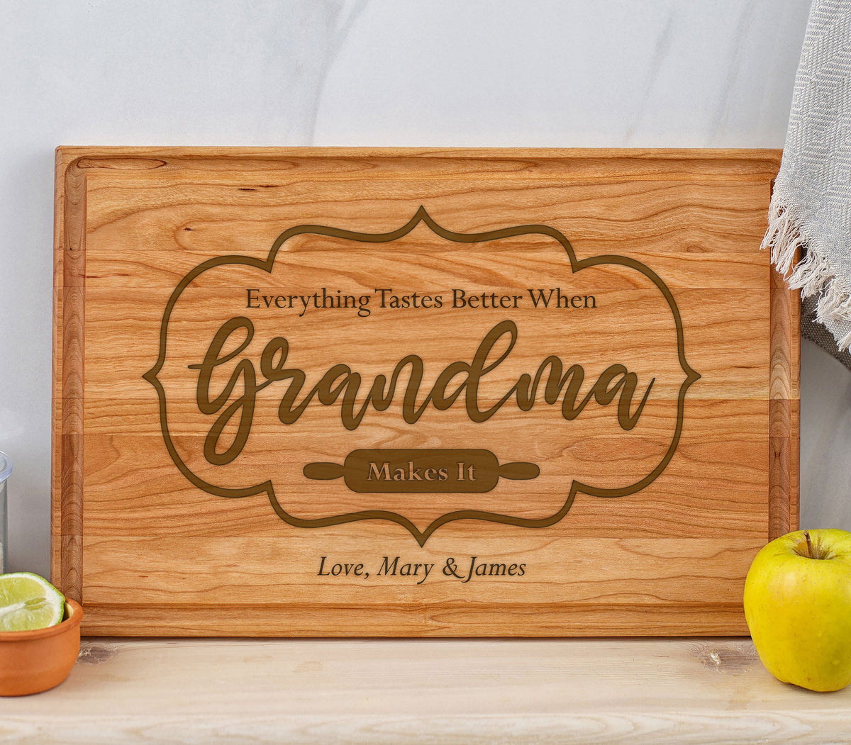 May include: A wooden cutting board with the text "Everything Tastes Better When Grandma Makes It" and the names "Love, Mary & James" engraved on it.