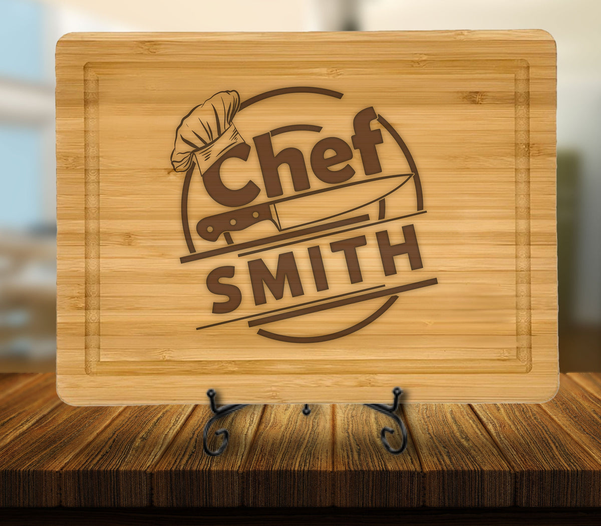 May include: A brown bamboo cutting board with a personalized design. The design features a chef's hat, a knife, and the text "Chef SMITH".