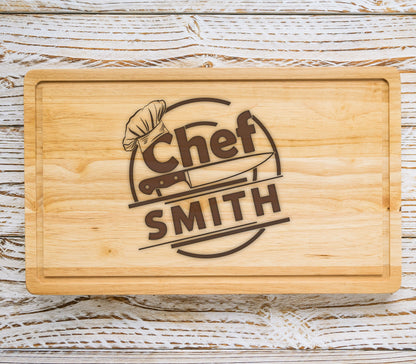 May include: A wooden cutting board with a brown engraved design that says "Chef SMITH" with a chef's hat and a knife.
