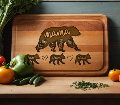 May include: Wooden cutting board with a bear design and the word "mama". The bear is surrounded by floral accents. Below the bear are three smaller bear figures with the names "Liam", "Oliver", and "Olivia".