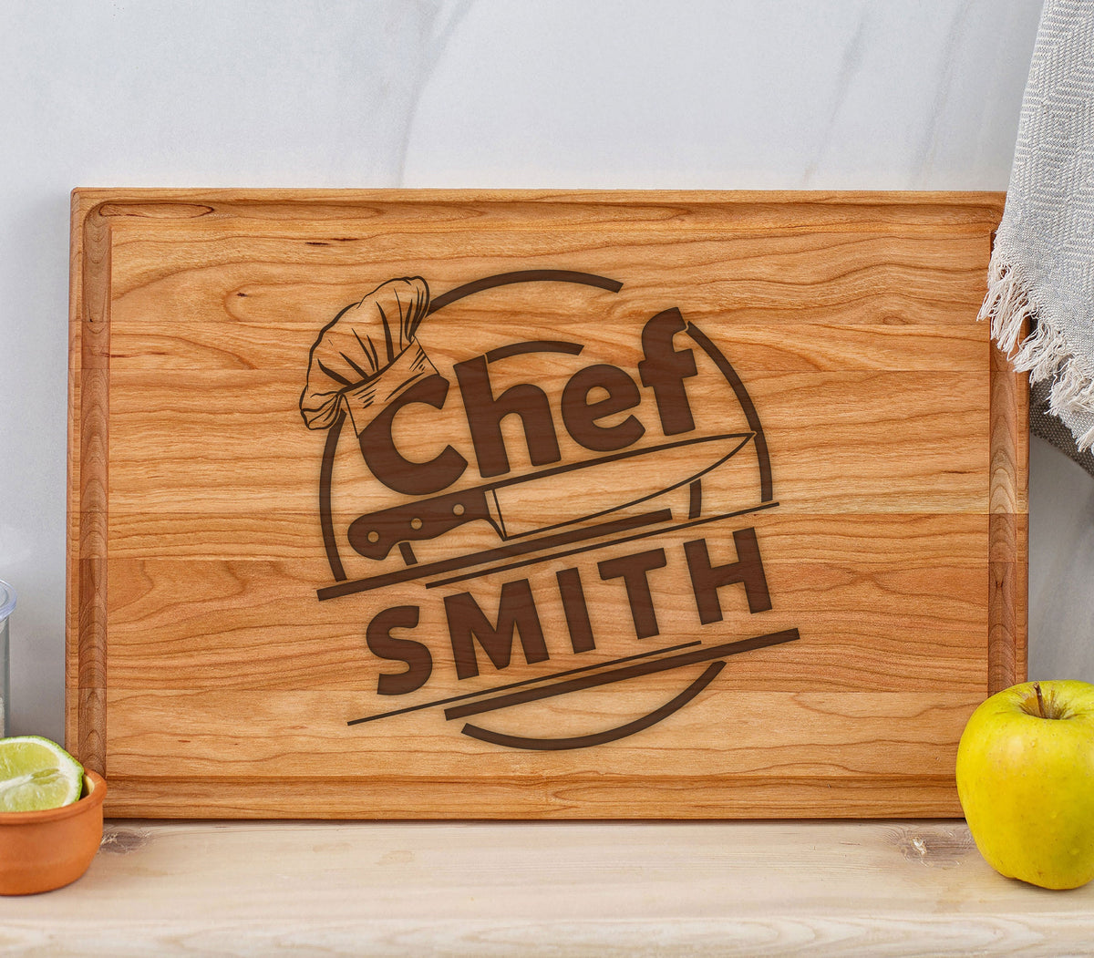 May include: A wooden cutting board with a brown engraved design that says "Chef SMITH" with a chef's hat and knife graphic.