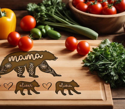 May include: Wooden cutting board with a bear design and the word "mama". Includes bear cub designs with the names "oliver" and "olivia". The board is surrounded by fresh vegetables, including tomatoes and parsley.