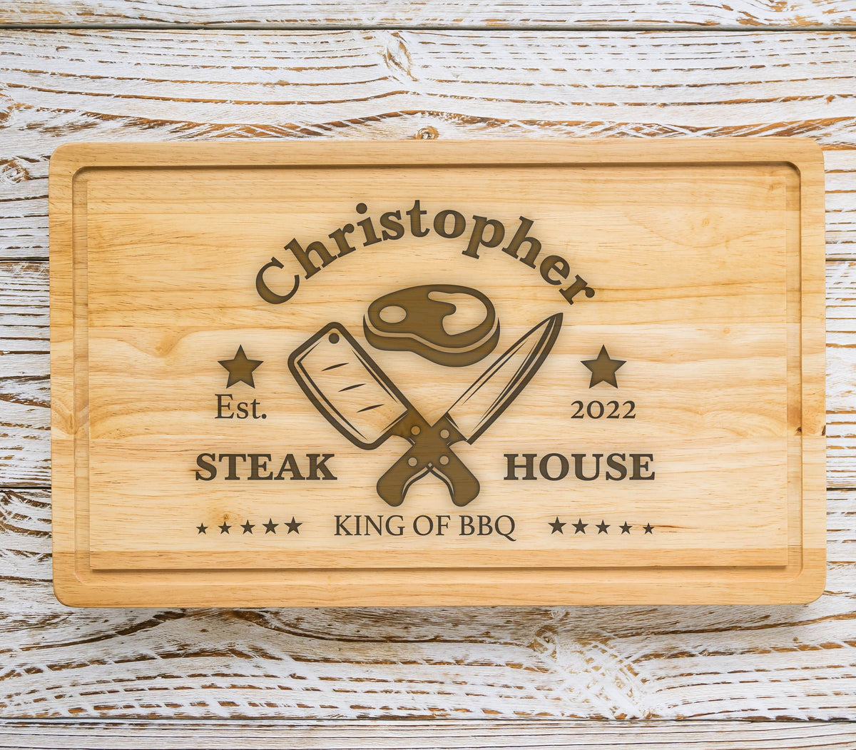 May include: A personalized wooden cutting board with the text "Christopher Steak House Est. 2022 King of BBQ" and a graphic of a steak and crossed knives.