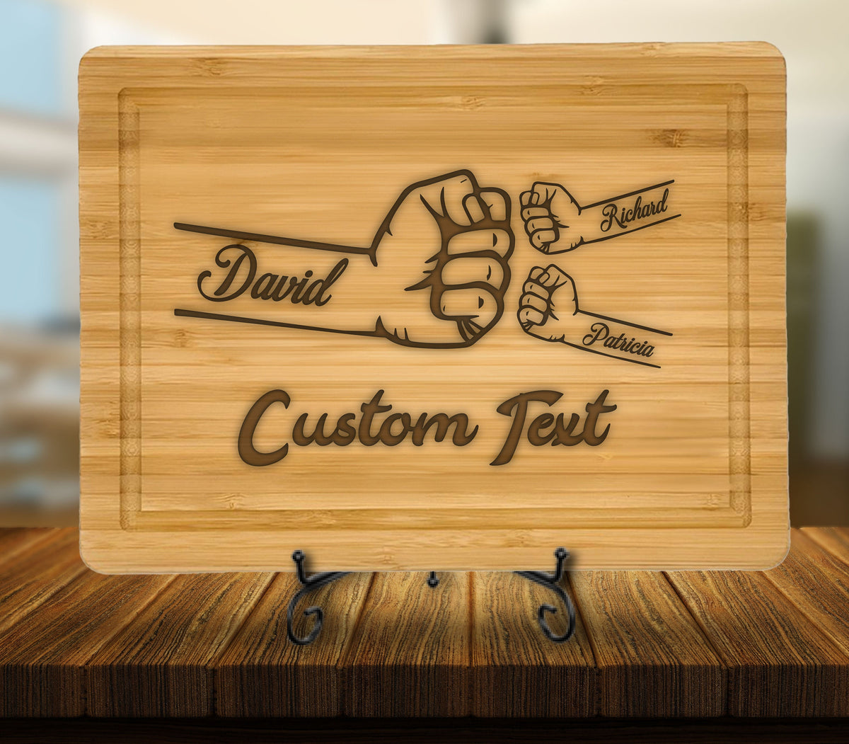 May include: A brown bamboo cutting board with a design of three fists bumping each other. The names "David", "Richard", and "Patricia" are engraved on the fists. The text "Custom Text" is also engraved on the board.