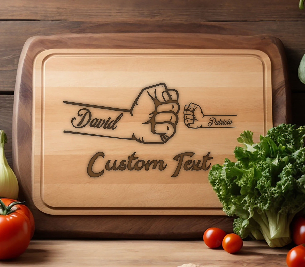 May include: A wooden cutting board with a brown walnut edge. The board has a design of two fists bumping with the names "David" and "Patricia" and the text "Custom Text" engraved on it.