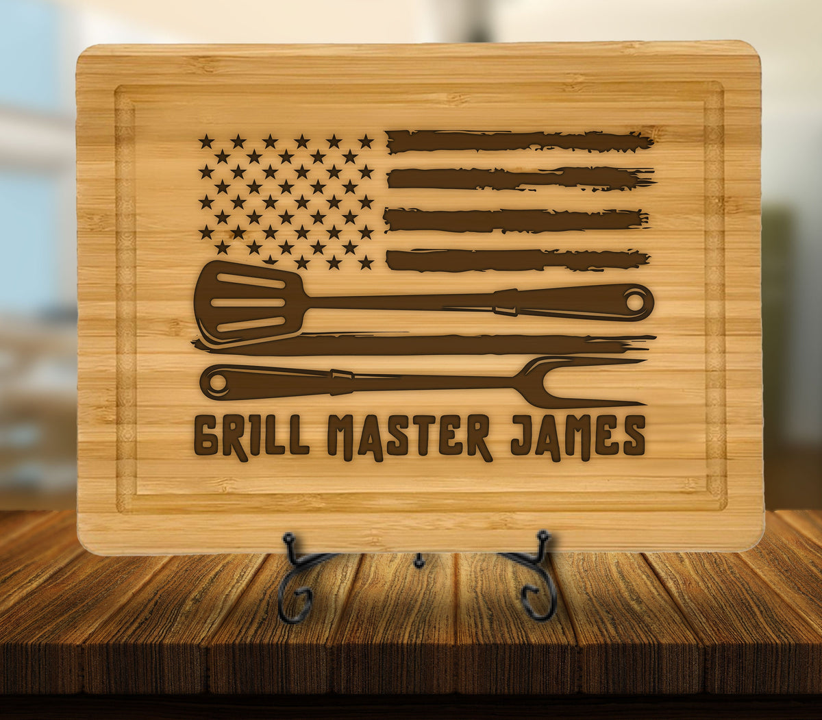 May include: A brown bamboo cutting board with a distressed American flag design, three grilling tools, and the text "Grill Master James".