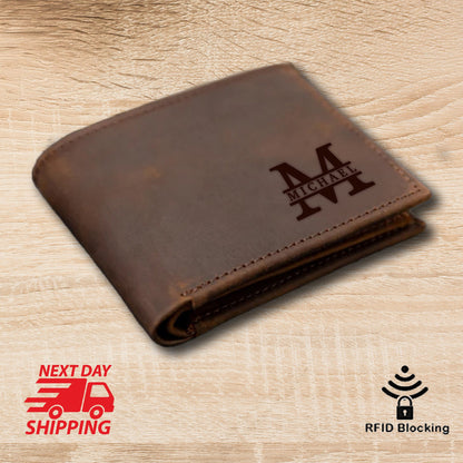 May include: A brown leather wallet with the name "MICHAEL" and the letter "M" engraved on the front. The wallet is closed and has a slightly distressed appearance. The image also includes the text "NEXT DAY SHIPPING" and "RFID Blocking".