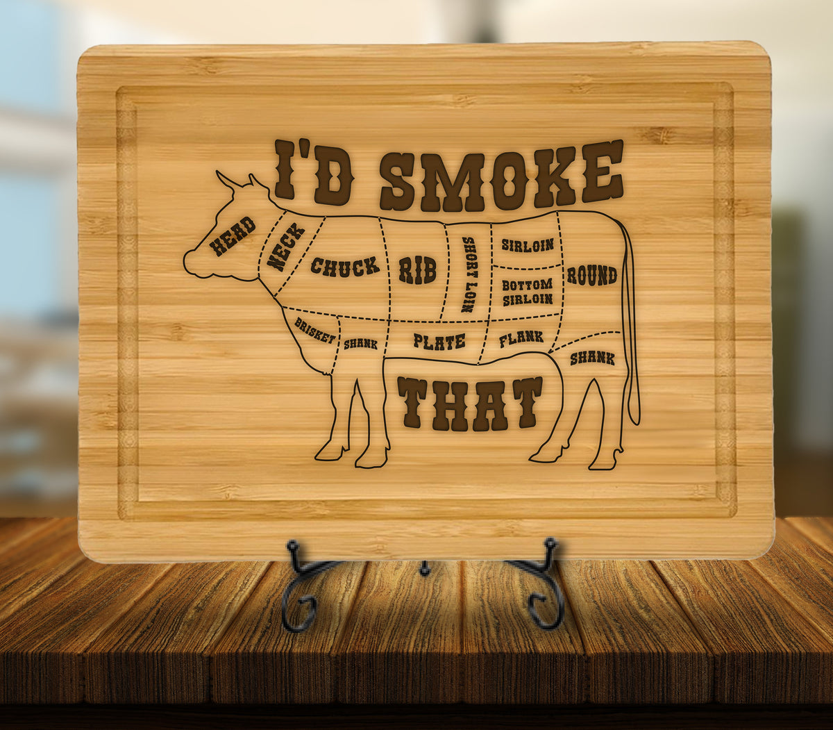 May include: A wooden cutting board with a cow silhouette and the text "I'D SMOKE THAT". The cow is divided into different cuts of meat, including chuck, rib, short loin, sirloin, bottom sirloin, flank, and round.