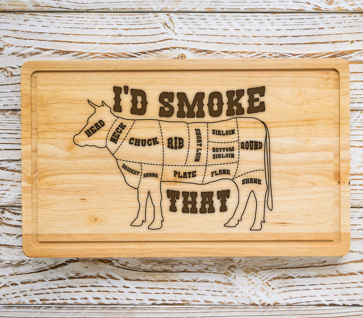 May include: A wooden cutting board with a silhouette of a cow and the text "I'D SMOKE THAT". The cow is divided into different cuts of meat, including chuck, rib, short loin, sirloin, bottom sirloin, round, flank, brisket, shank, and plate.