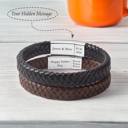 May include: Two-toned leather bracelet with a braided design. The bracelet has two silver metal plates with engraved text: "James & Mary 07.01.2024" and "Happy Father Day David Susan Karen".
