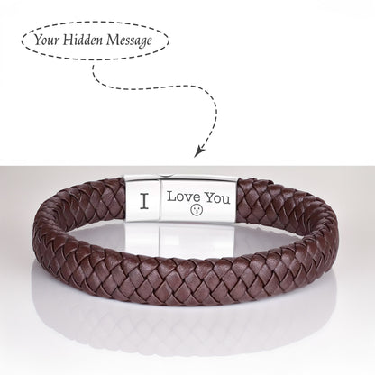 May include: A brown leather bracelet with a silver clasp. The clasp has the words "I Love You" engraved on it.