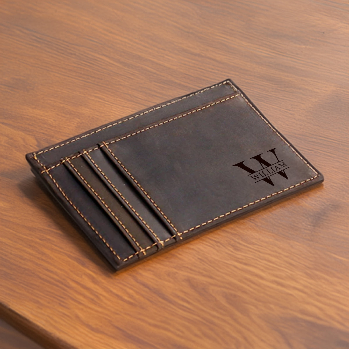 May include: A brown leather wallet with a monogrammed initial "W" and the name "William" engraved on the front. The wallet has multiple card slots.