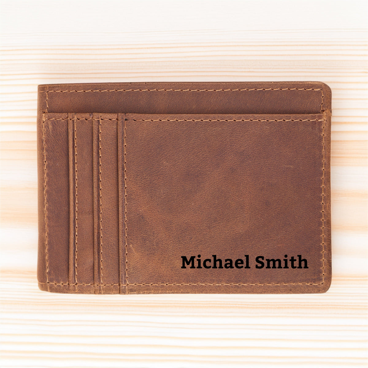 May include: A brown leather wallet with a stitched edge and the name "Michael Smith" embossed on the front.