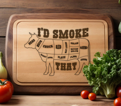 May include: A wooden cutting board with a brown cow silhouette and the text "I'D SMOKE THAT" on it. The cow is divided into different cuts of meat, including chuck, rib, short loin, sirloin, bottom sirloin, and round.