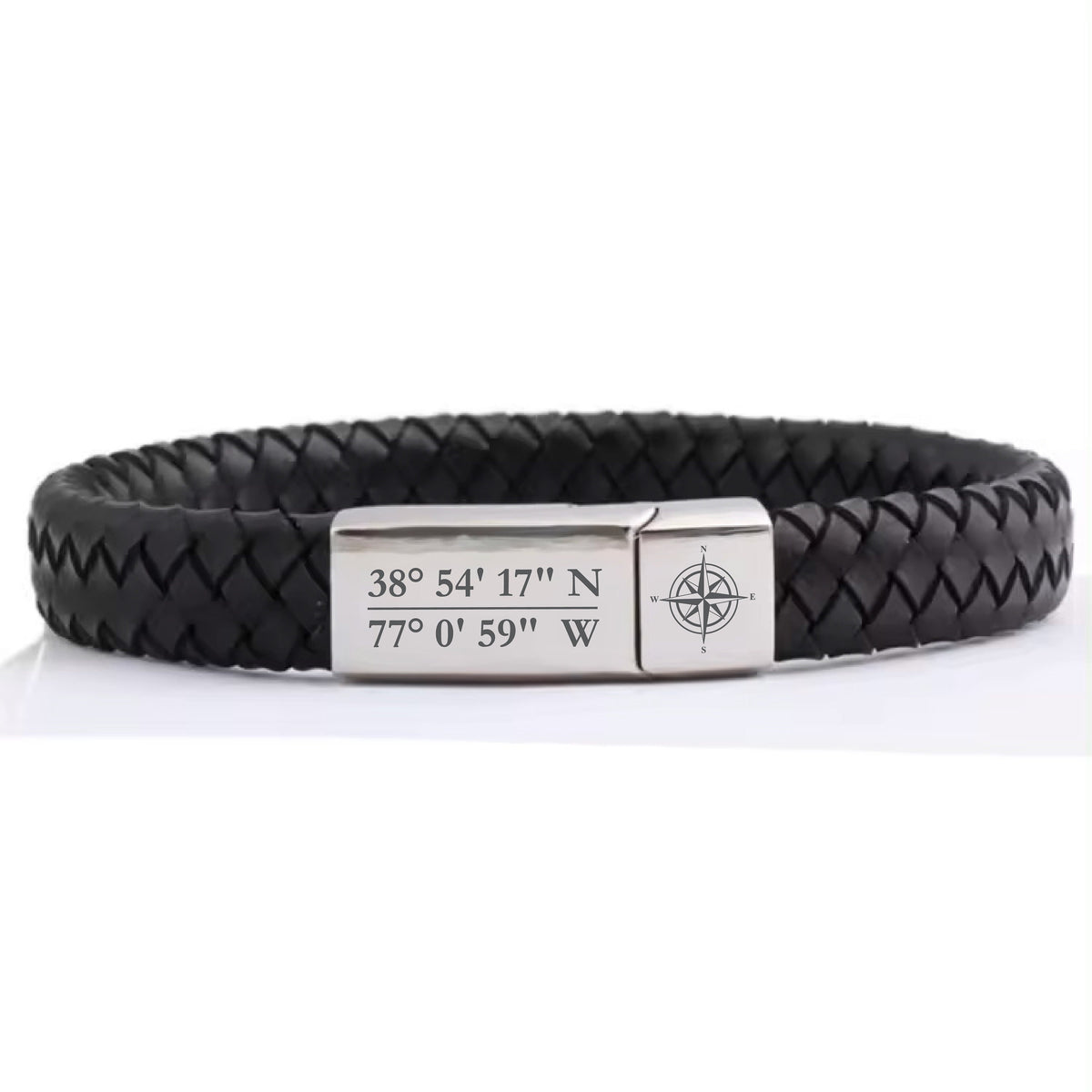 May include: Black leather bracelet with a silver compass charm and engraved coordinates: 38° 54' 17" N 77° 0' 59" W.
