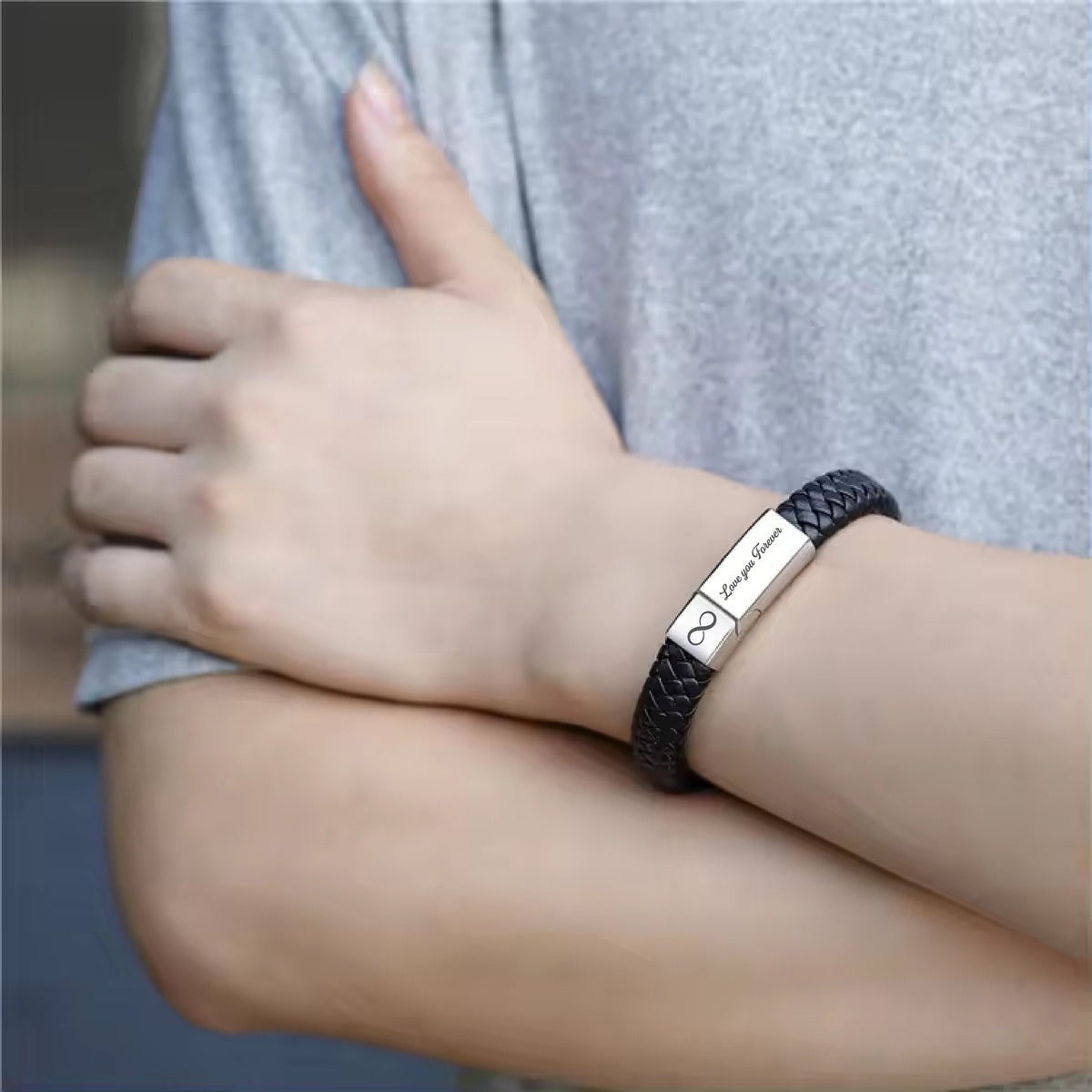 May include: Black leather bracelet with a silver infinity symbol and the inscription "Love you Forever".