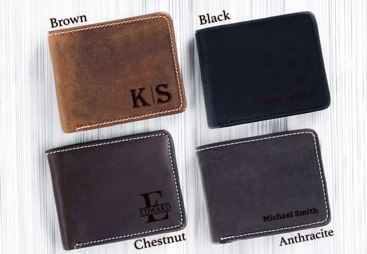 May include: Four leather wallets in different colors: brown, black, chestnut, and anthracite. Each wallet has a different personalized inscription. The brown wallet has the initials "K/S" engraved. The black wallet has the name "Robert Johnson" engraved. The chestnut wallet has the initial "E" with the word "EDWARD" engraved below. The anthracite wallet has the name "Michael Smith" engraved.