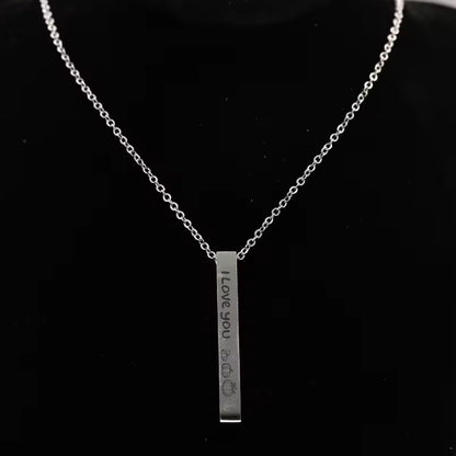 May include: A silver necklace with a vertical bar pendant that reads "I Love You" with a heart and three pumpkins engraved on it.
