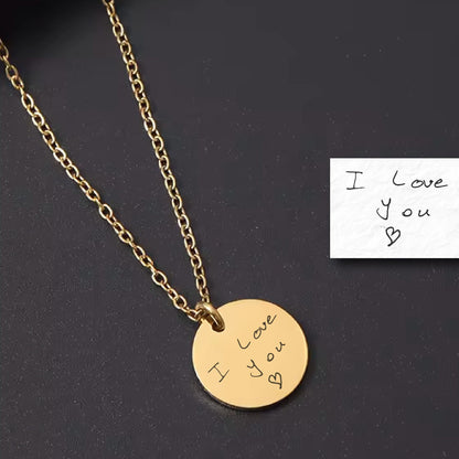 May include: Gold necklace with a round pendant that says "I love you" in handwritten script. The pendant is on a gold chain.