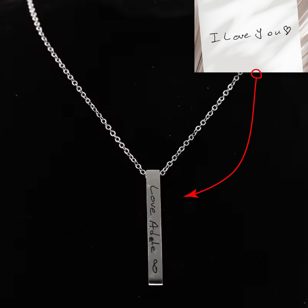 May include: A silver necklace with a vertical bar pendant engraved with the words "Love Adele" and an infinity symbol.
