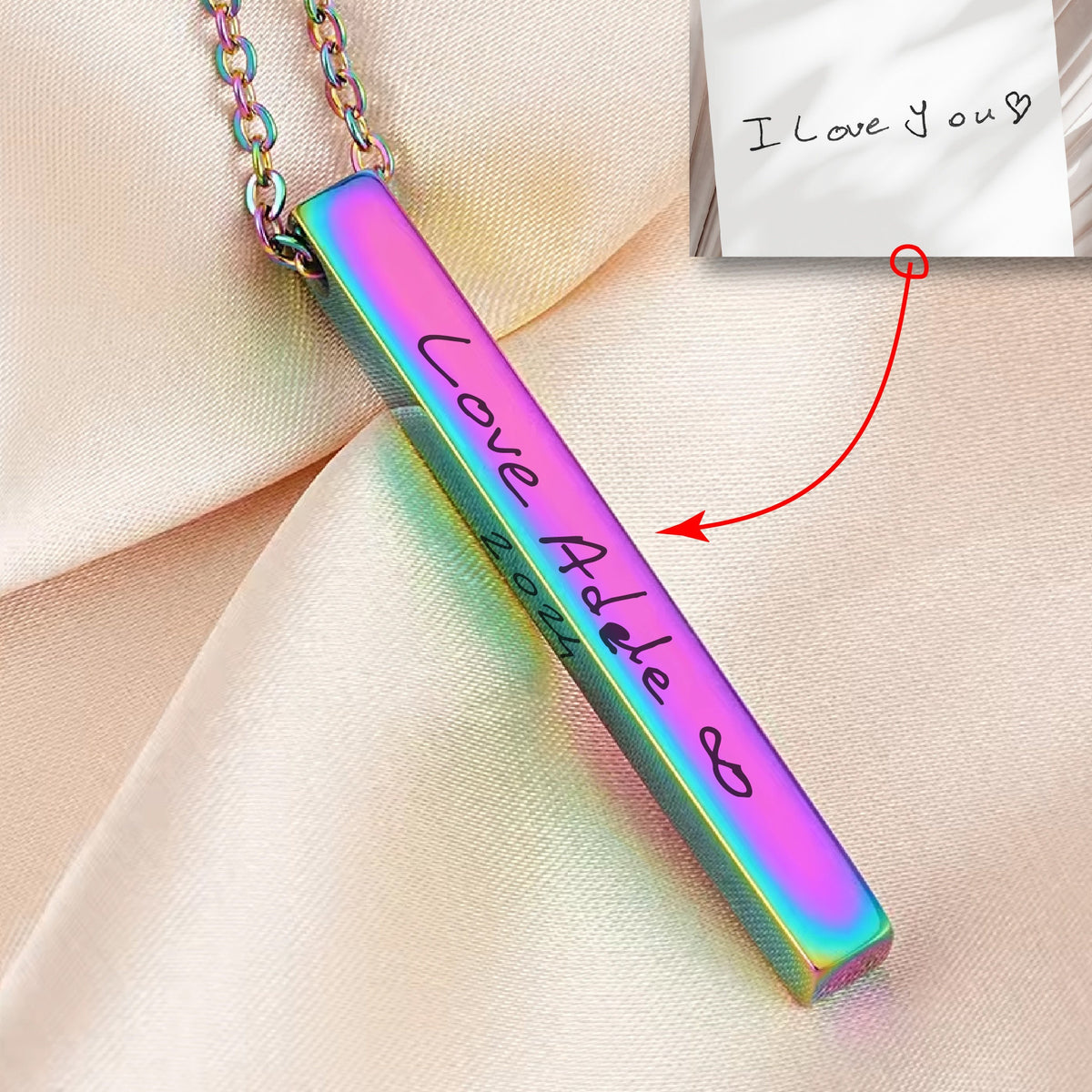 May include: A rainbow iridescent bar necklace with the inscription "Love Adele" and the year "2021".