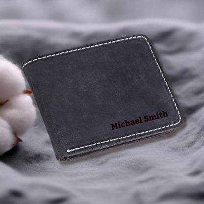 May include: A black leather wallet with white stitching and the name "Michael Smith" embossed in brown lettering.