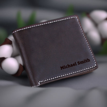 May include: A brown leather wallet with white stitching and the name "Michael Smith" embossed in brown lettering.