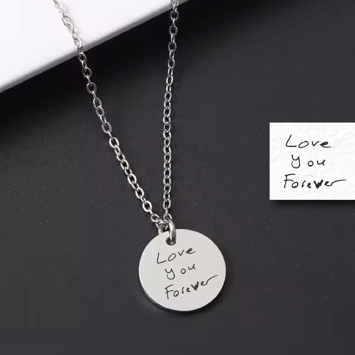 May include: A silver necklace with a round pendant that says "Love you Forever" in handwritten script. The pendant is on a silver chain.