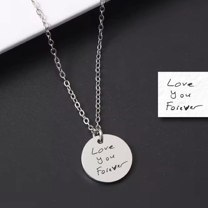 May include: A silver necklace with a round pendant that says "Love you Forever" in handwritten script. The pendant is on a silver chain.