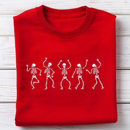 May include: A bright red sweatshirt featuring a white graphic of five dancing skeletons. The skeletons are in various poses with their arms raised. The sweatshirt is folded neatly on a light wood surface.