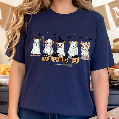 May include: A navy blue t-shirt featuring a graphic print of five dogs dressed as ghosts, with some wearing witch hats and sitting in or near orange jack-o'-lantern pumpkins. The design includes small black bats, yellow stars, and a broomstick.