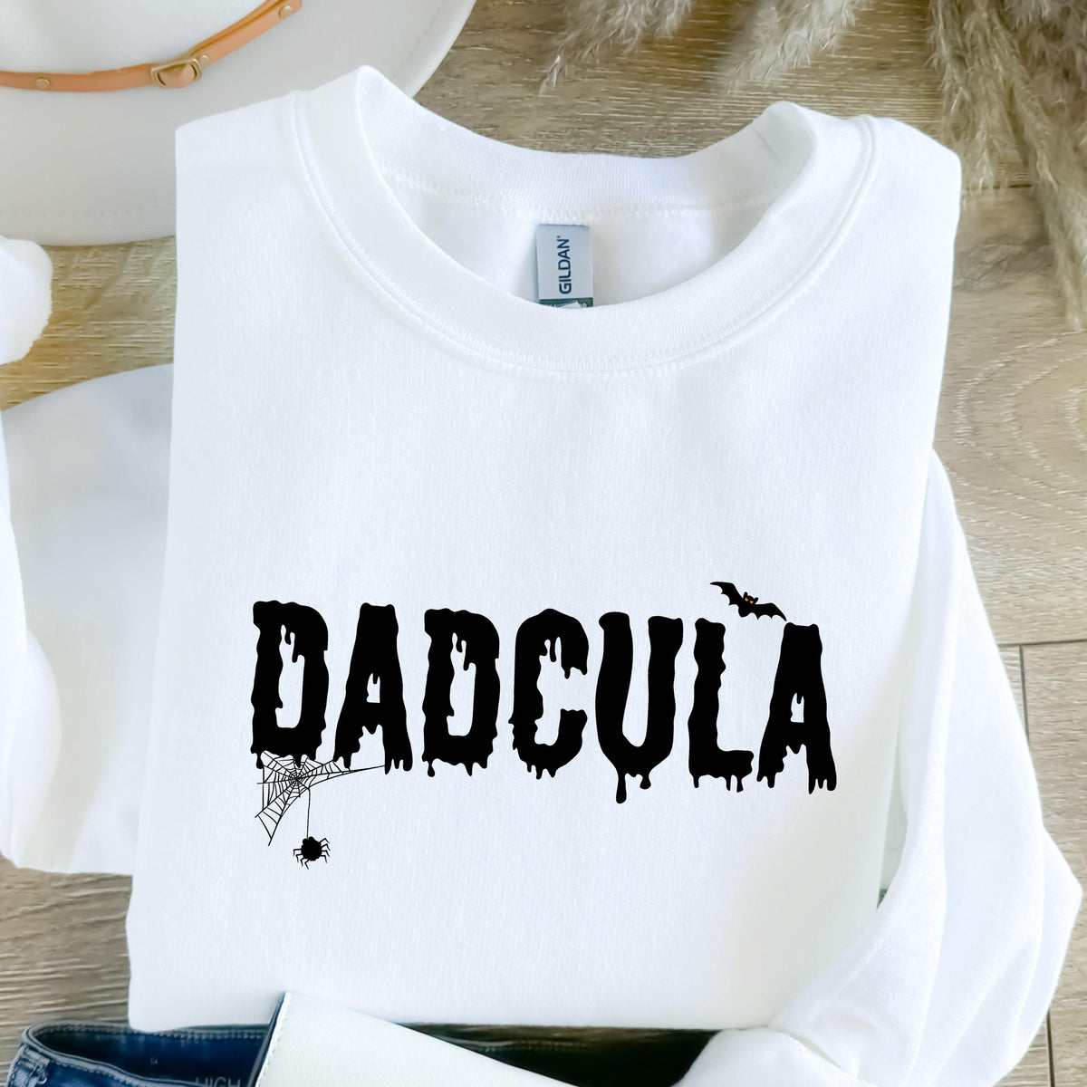 May include: White sweatshirt with a black graphic that says "DADCULA" in dripping letters with a spider and web to the left and a bat to the right.