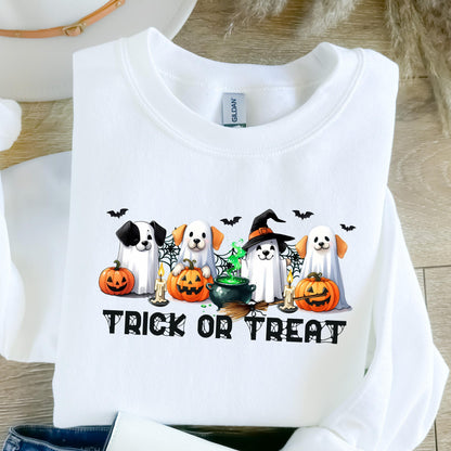 May include: White sweatshirt featuring a Halloween-themed graphic. The design includes four dogs dressed as ghosts, pumpkins, bats, a witch's hat, and the words "Trick or Treat" in black. The sweatshirt is made of a soft material.