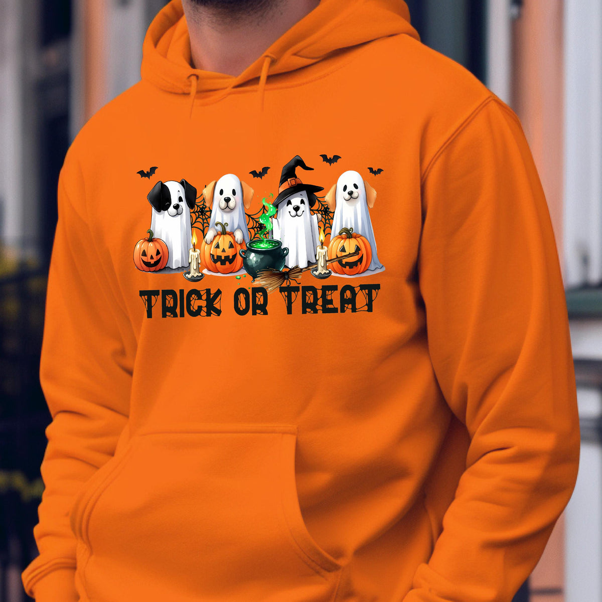 May include: Orange Halloween hoodie with a graphic featuring four cartoon ghosts, pumpkins, candles, and bats. The text "TRICK OR TREAT" is printed below the graphic. The hoodie has a front pocket and a hood.