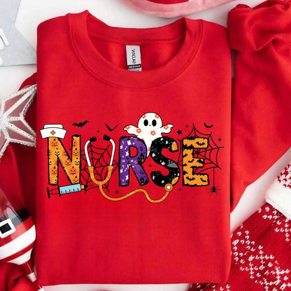 May include: A red sweatshirt with the word "NURSE" in a Halloween-themed design. The letters are decorated with a nurse's hat, a syringe, a stethoscope, spiderwebs, bats, and a ghost. The sweatshirt is made of a soft material.