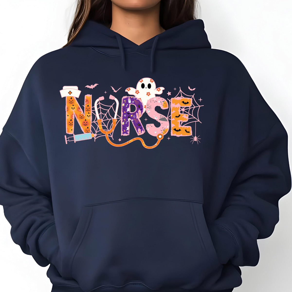 May include: Navy blue hoodie with a colorful Halloween-themed "NURSE" graphic. The design includes a ghost, bats, spiderwebs, and a stethoscope. The letters are decorated with pumpkins and other spooky elements.
