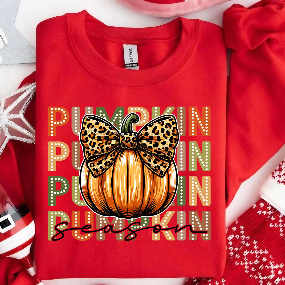 May include: Red sweatshirt with a pumpkin graphic. The pumpkin is orange with a leopard print bow. The words "PUMPKIN SEASON" are printed on the sweatshirt in white, green, and orange.