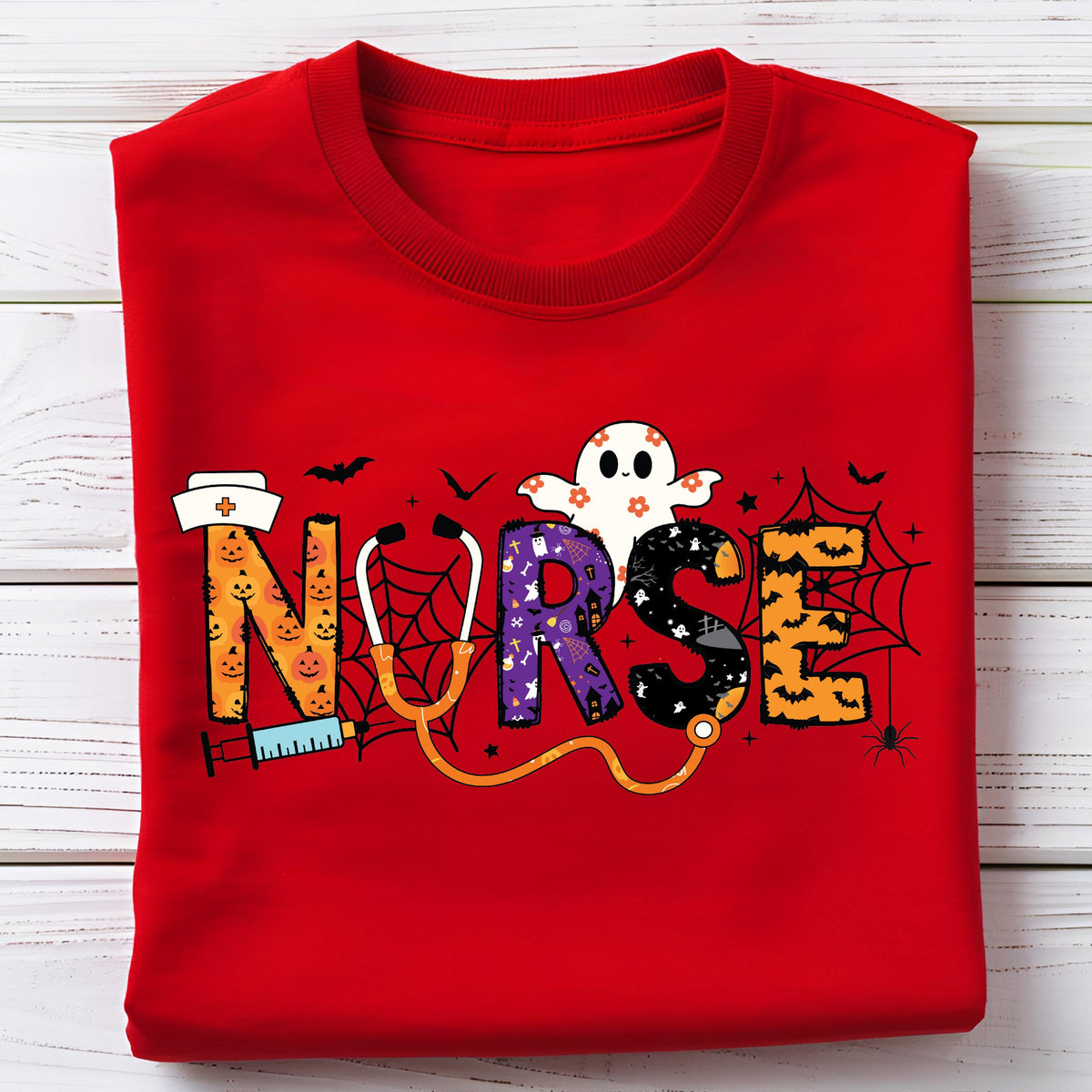 May include: A red crew neck sweatshirt with a Halloween-themed design. The word "NURSE" is spelled out with a stethoscope, a ghost, and other Halloween elements. The letters are decorated with pumpkins, spiderwebs, and bats.