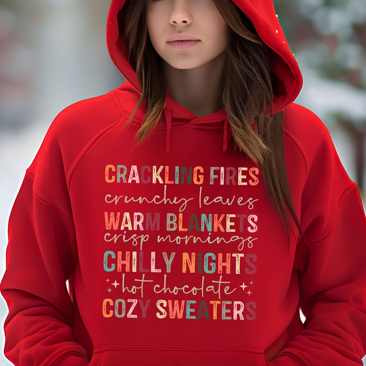 May include: Red hooded sweatshirt with a colorful graphic print that reads "Crackling Fires, Crunchy Leaves, Warm Blankets, Crisp Mornings, Chilly Nights, + Hot Chocolate +, Cozy Sweaters".