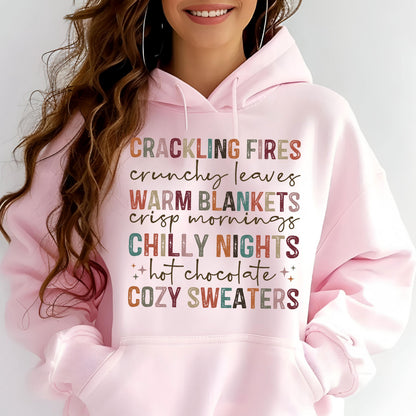 May include: Pink hoodie with a text design that reads "Crackling Fires, Crunchy Leaves, Warm Blankets, Crisp Mornings, Chilly Nights, Hot Chocolate, Cozy Sweaters". The text is in various colors and fonts.
