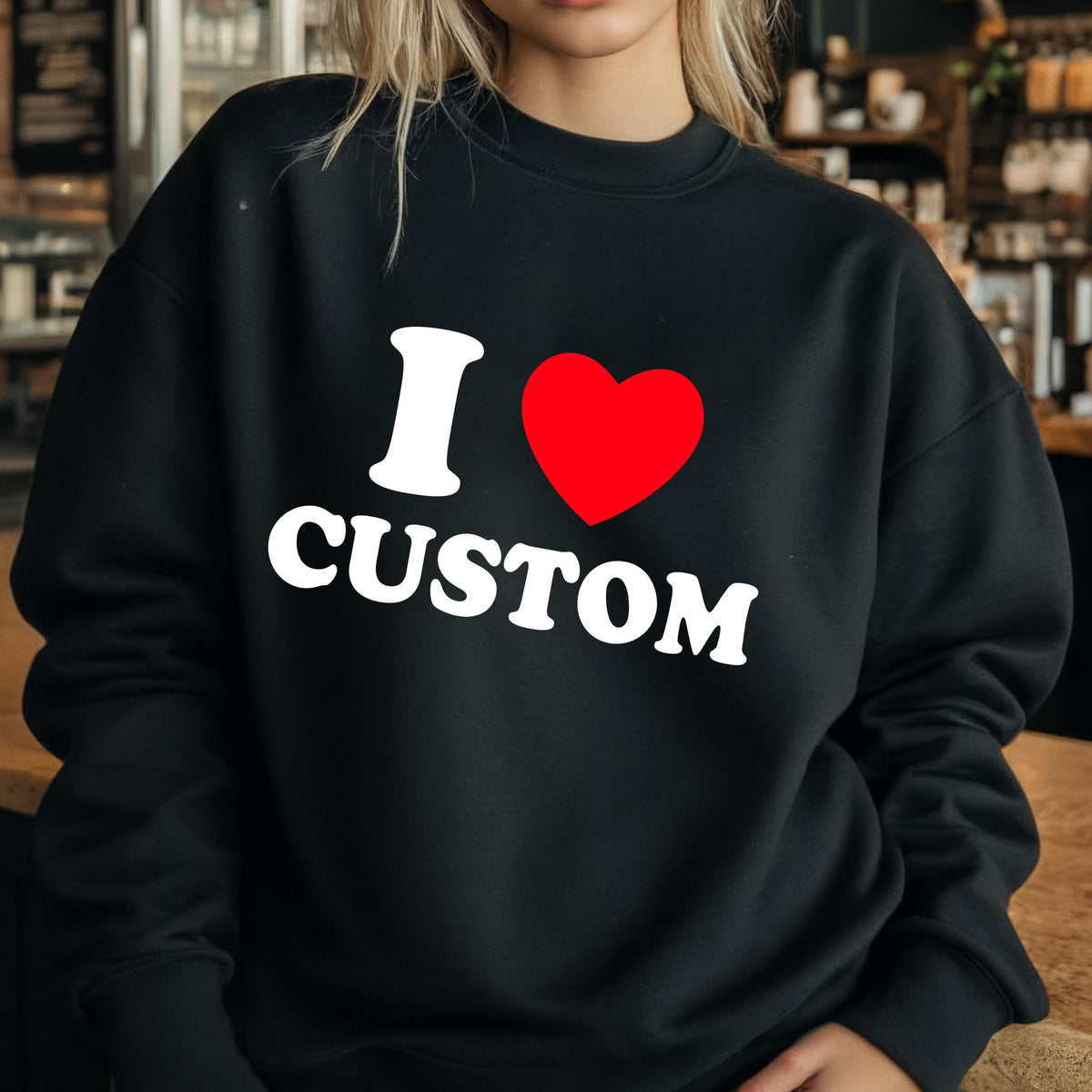 May include: Black sweatshirt with the text "I ♥ CUSTOM" in white and a red heart. The sweatshirt is a crew neck style, and the text is centered on the chest.