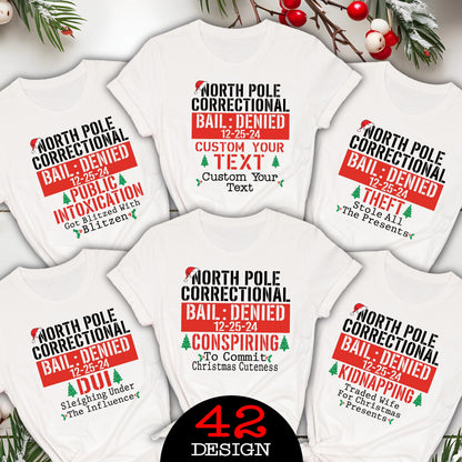 May include: White t-shirts with various humorous Christmas-themed designs. Each shirt features the text "North Pole Correctional Bail: Denied" with different charges like "Public Intoxication" and "Kidnapping". The number "42" and the word "Design" are also visible.