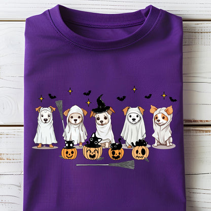 May include: A purple t-shirt featuring a graphic print of five dogs wearing white ghost costumes and witch hats, accompanied by four orange jack-o'-lanterns with black cats inside, small black bats, and yellow stars scattered across the design.